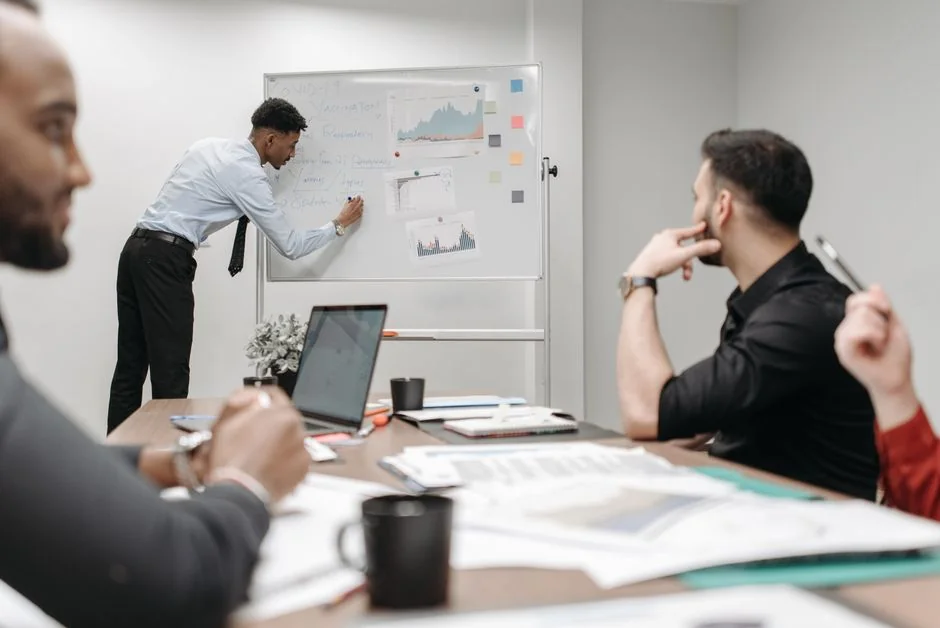 Cropped shot of an anonymous male instructor using a marker on a whiteboard during social media training sessions